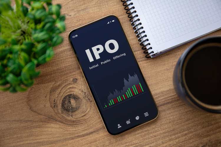golden phone with IPO stocks purchase app on the screen