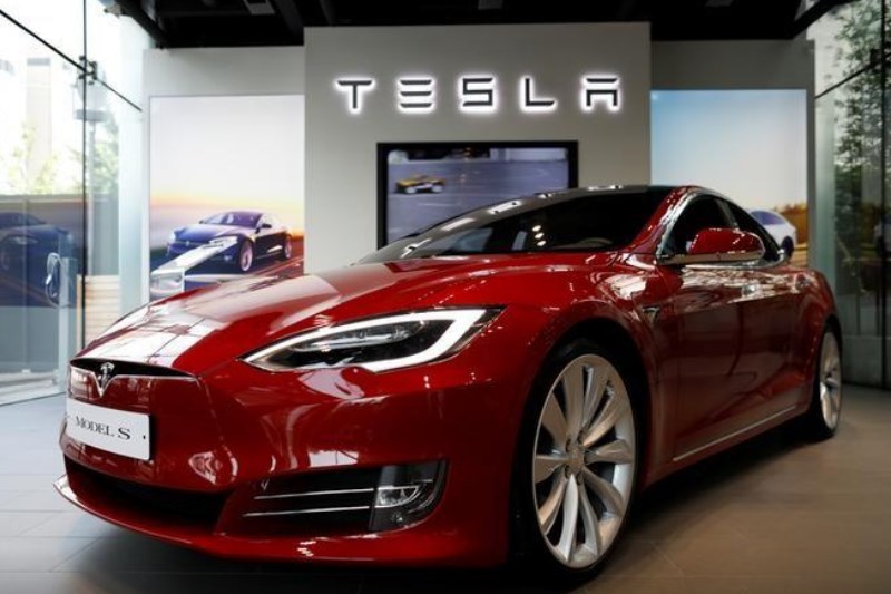 Tesla's robot waves but can't walk, yet. Musk plans to make millions of them By Reuters