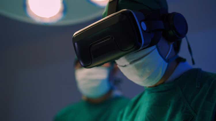 Doctors in VR glasses performing surgery in hospital.